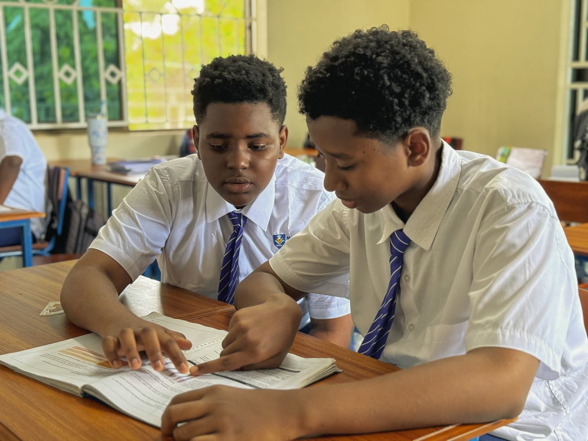 Two Montana students working together on a textbook